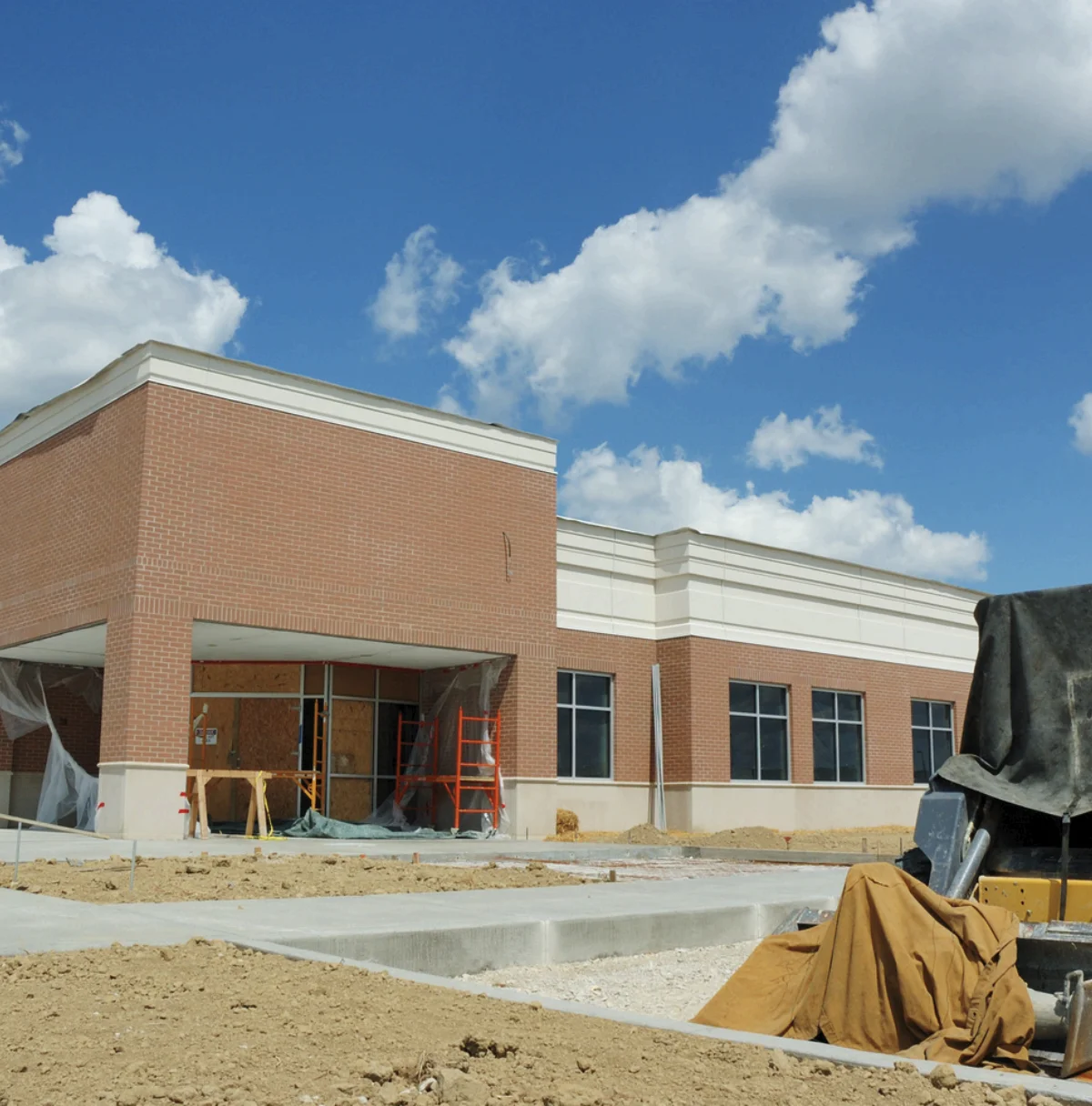Commercial school building under construction with masonry and sitework in progress